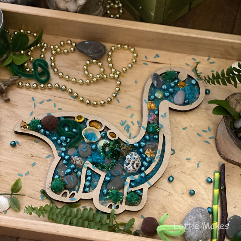 Dinosaur loose parts sensory tray play