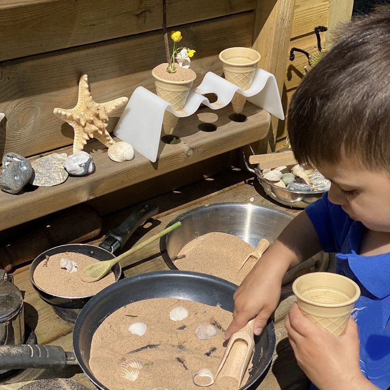 exploring sand in the mud kitchen